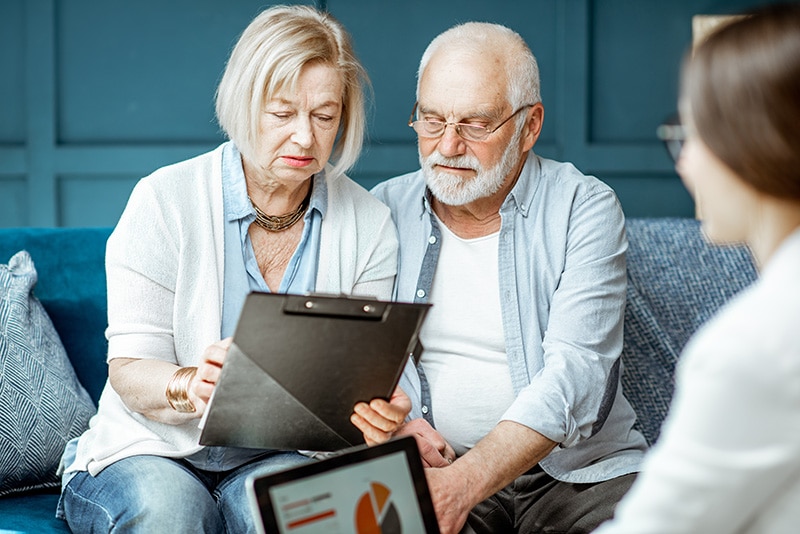 Older Couple Reviewing Legal Documents in the Presence of Attorney