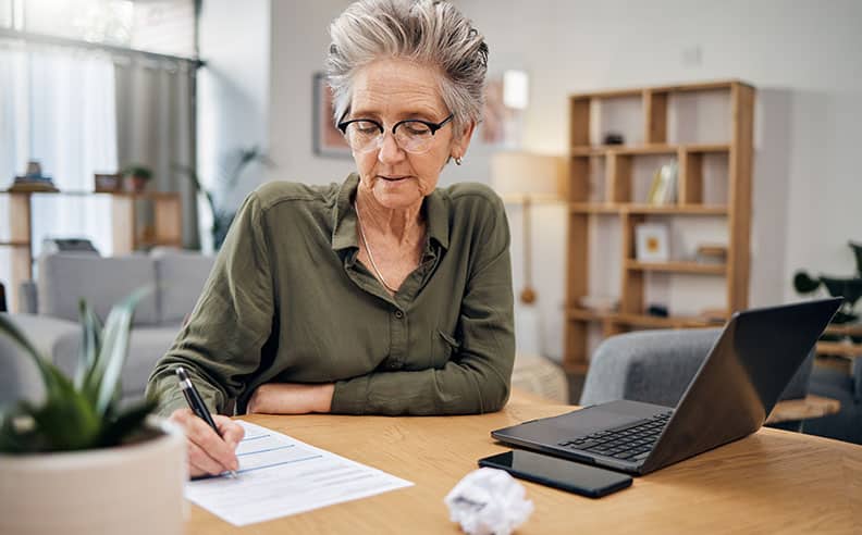 Senior Woman Filling Out Legal Paperwork